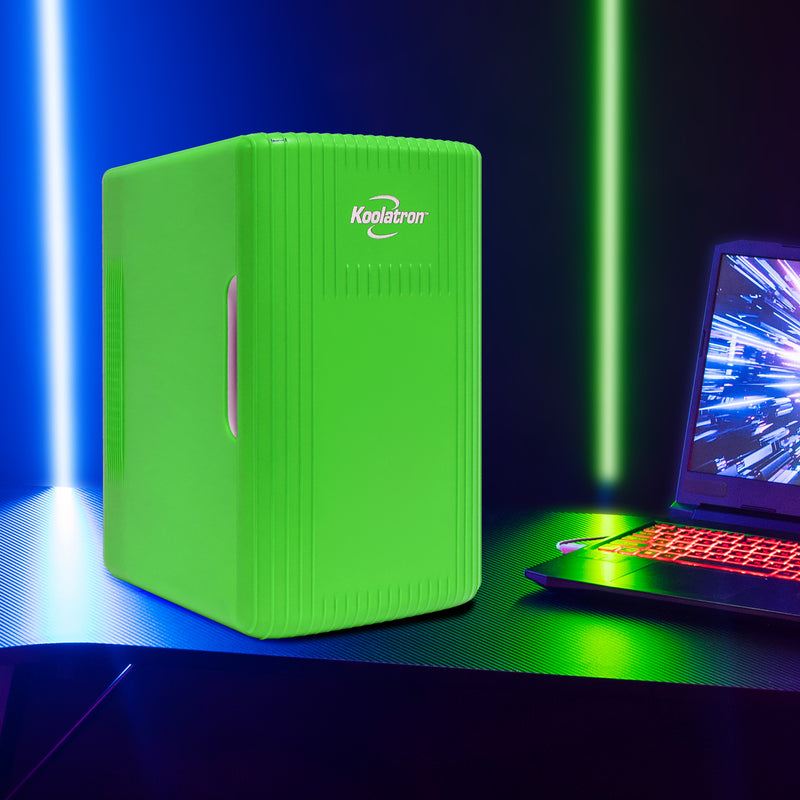 Koolatron 8 can mini fridge, closed, on a black desk with bright green and blue LED lights behind it and a black gaming laptop with lighted keyboard to the right