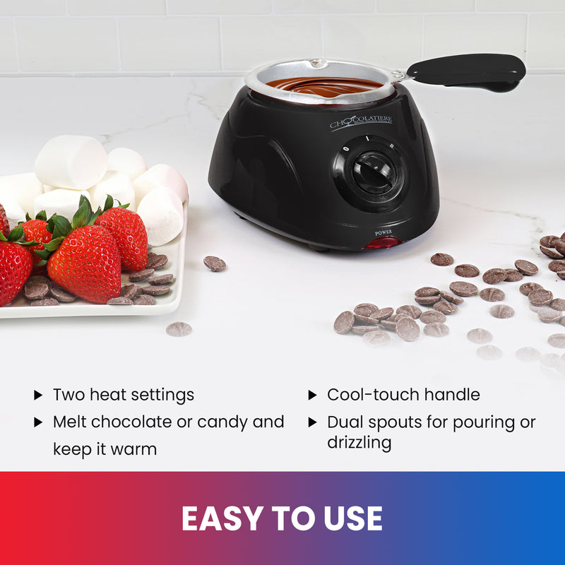Lifestyle image of chocolate fondue pot on a white counter with a plate of strawberries and marshmallows on the left and unmelted chocolate discs on the right. Text below reads, "Easy to use: Two heat settings; Melt chocolate and keep it warm; 8.8 oz (250 gram) capacity; Cool-touch handle; Dual spouts for pouring or drizzling"