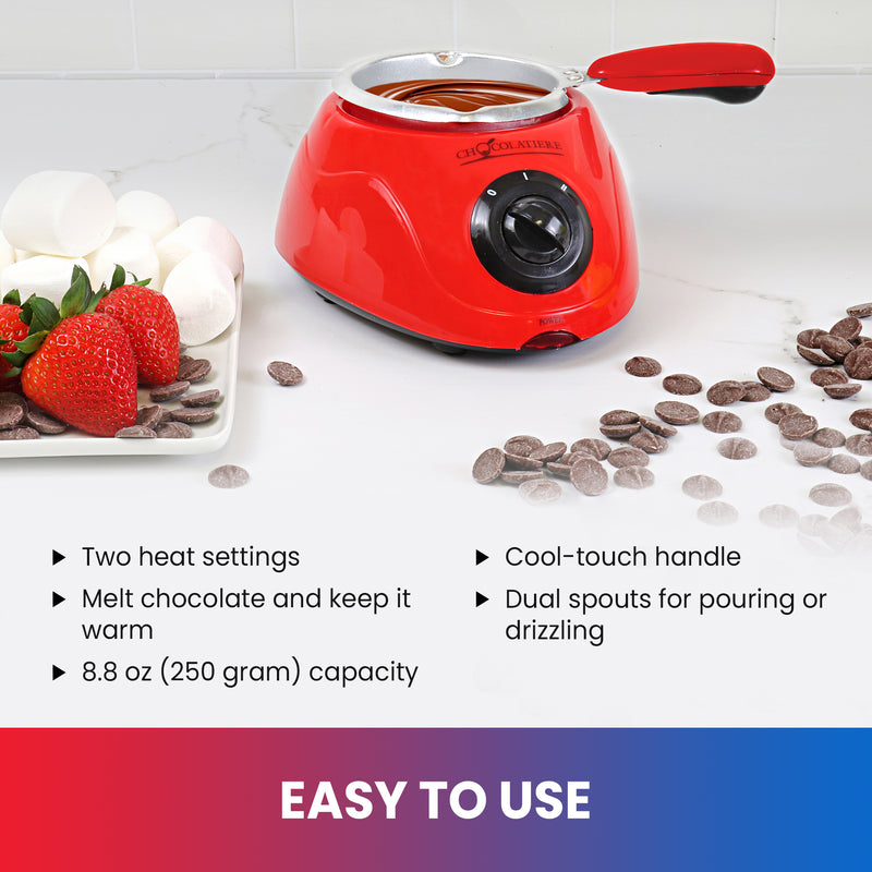 Lifestyle image of chocolate fondue pot on a white counter with a plate of strawberries and marshmallows on the left and unmelted chocolate discs on the right. Text below reads, "Easy to use: Two heat settings; Melt chocolate and keep it warm; 8.8 oz (250 gram) capacity; Cool-touch handle; Dual spouts for pouring or drizzling"